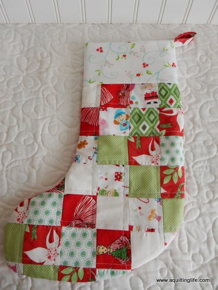 15 things to make for Christmas featured by Top US Quilt Blog, A Quilting Life: image of patchwork Christmas stocking