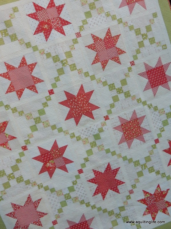 15 things to Make for Christmas featured by top US Quilting Blog, A Quilting Life: image of scrappy Christmas quilt